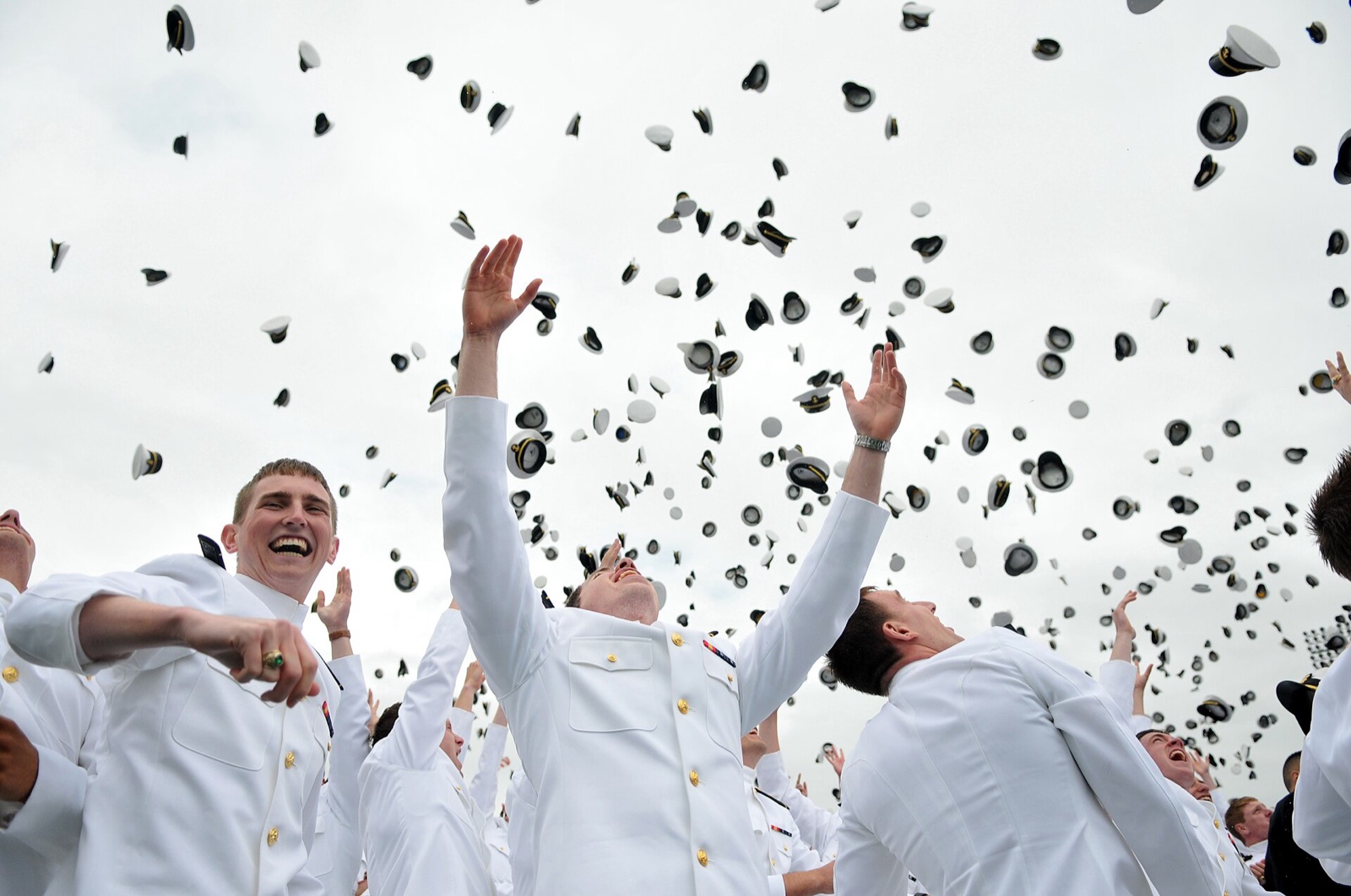 Graduates throw their caps in the air at commencement