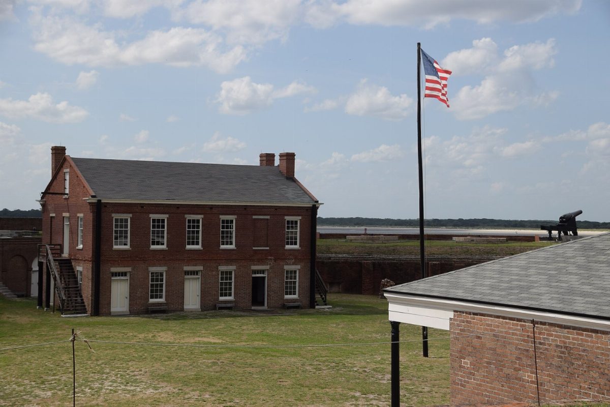 The two-story brick barracks inside Fort Clinch, with the U.S. flag flying over the parade ground.