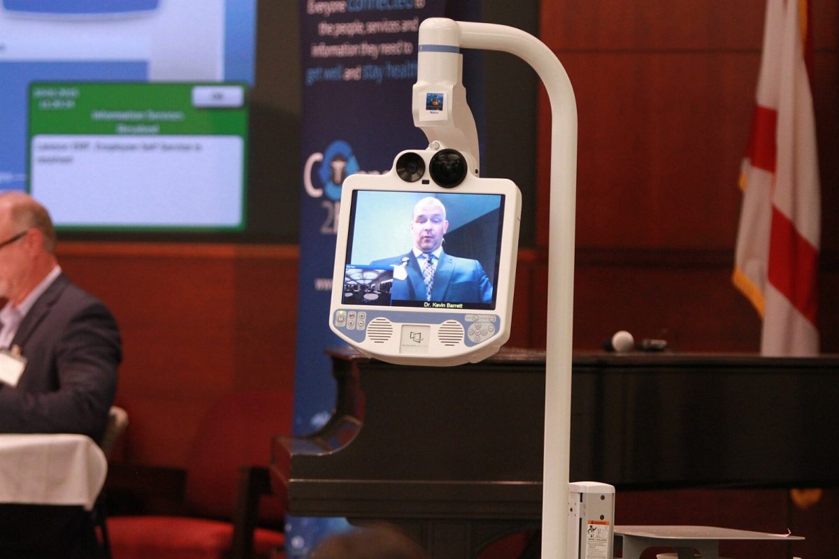 Dr. Kevin Barrett demonstrates Mayo Clinic's telestroke robot at the 2015 summit in Jacksonville.