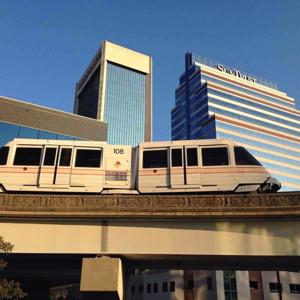 A Skyway train passes downtown Jacksonville towers (file photo). The free 2.5-mile monorail pauses Nov. 2 as JTA closes a $39 million budget gap.