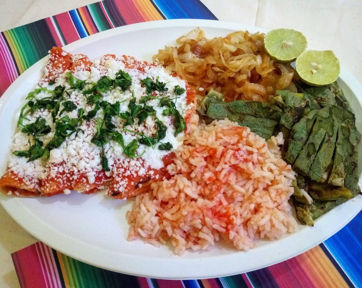 Red enchiladas with rice, grilled nopales and onions (file photo).