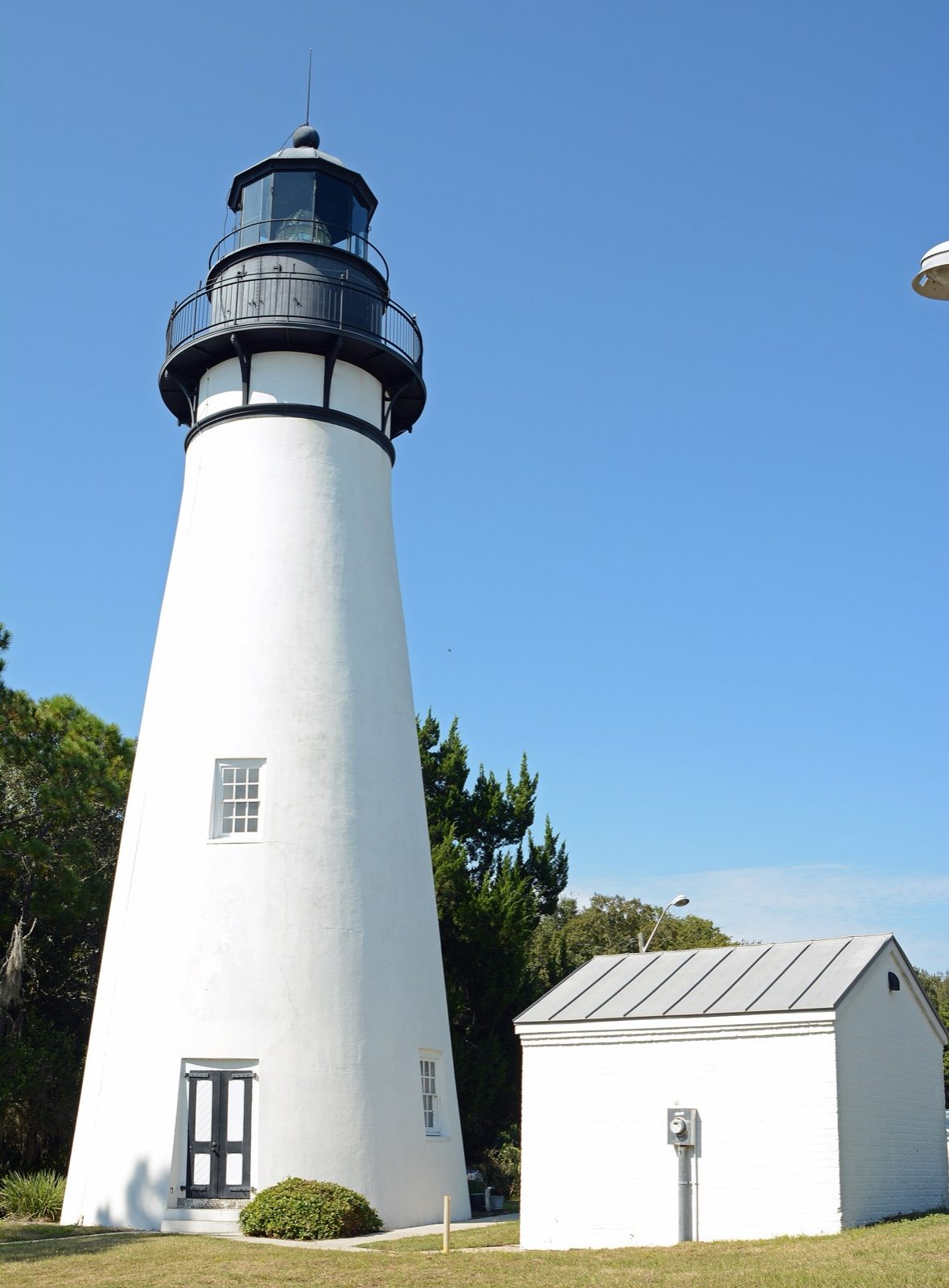 The Amelia Island Lighthouse and a neighboring building in Fernandina Beach.