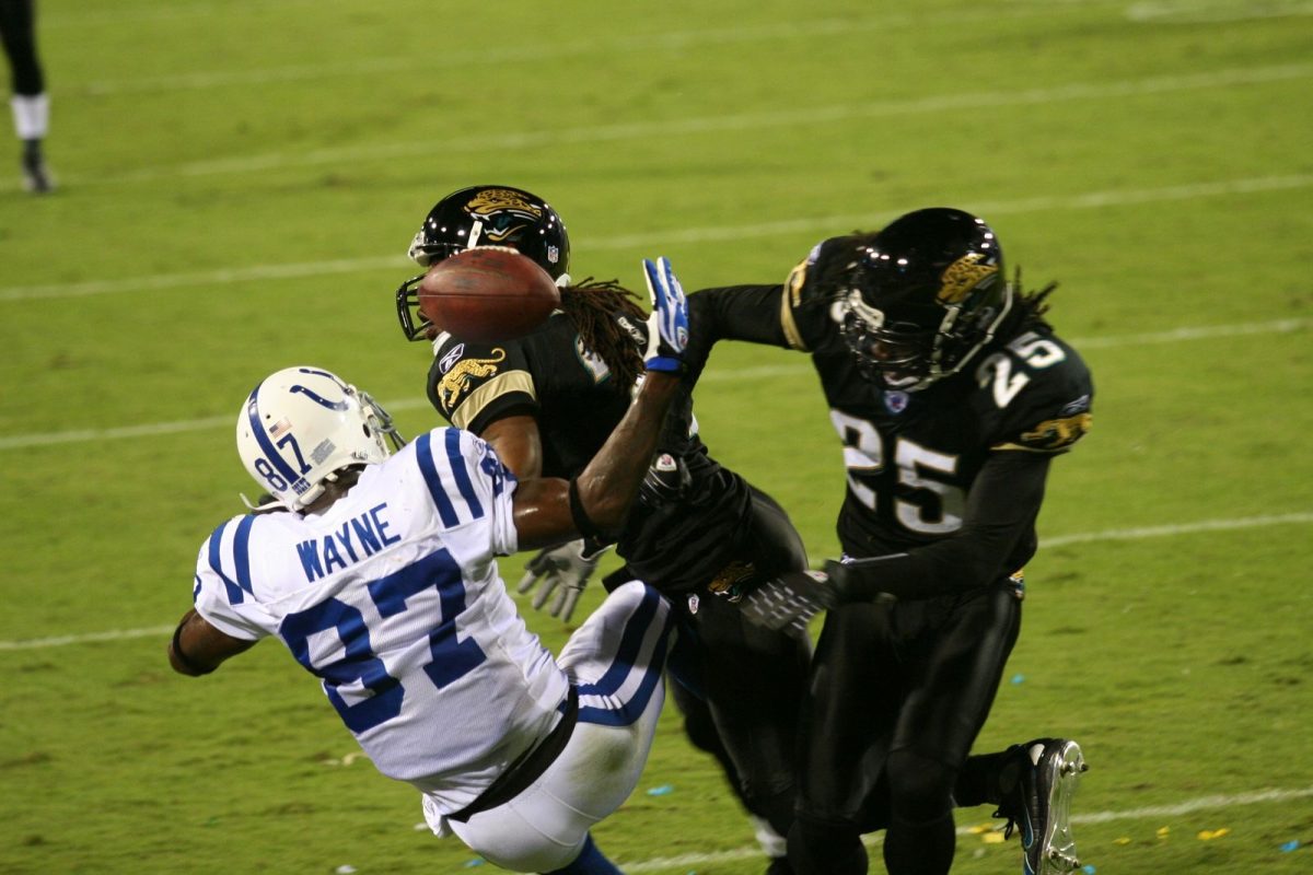 Colts receiver Reggie Wayne reaches for a pass as Jaguars defenders, including safety Reggie Nelson, close in during a Monday night game in Jacksonville in October 2007 (file photo).