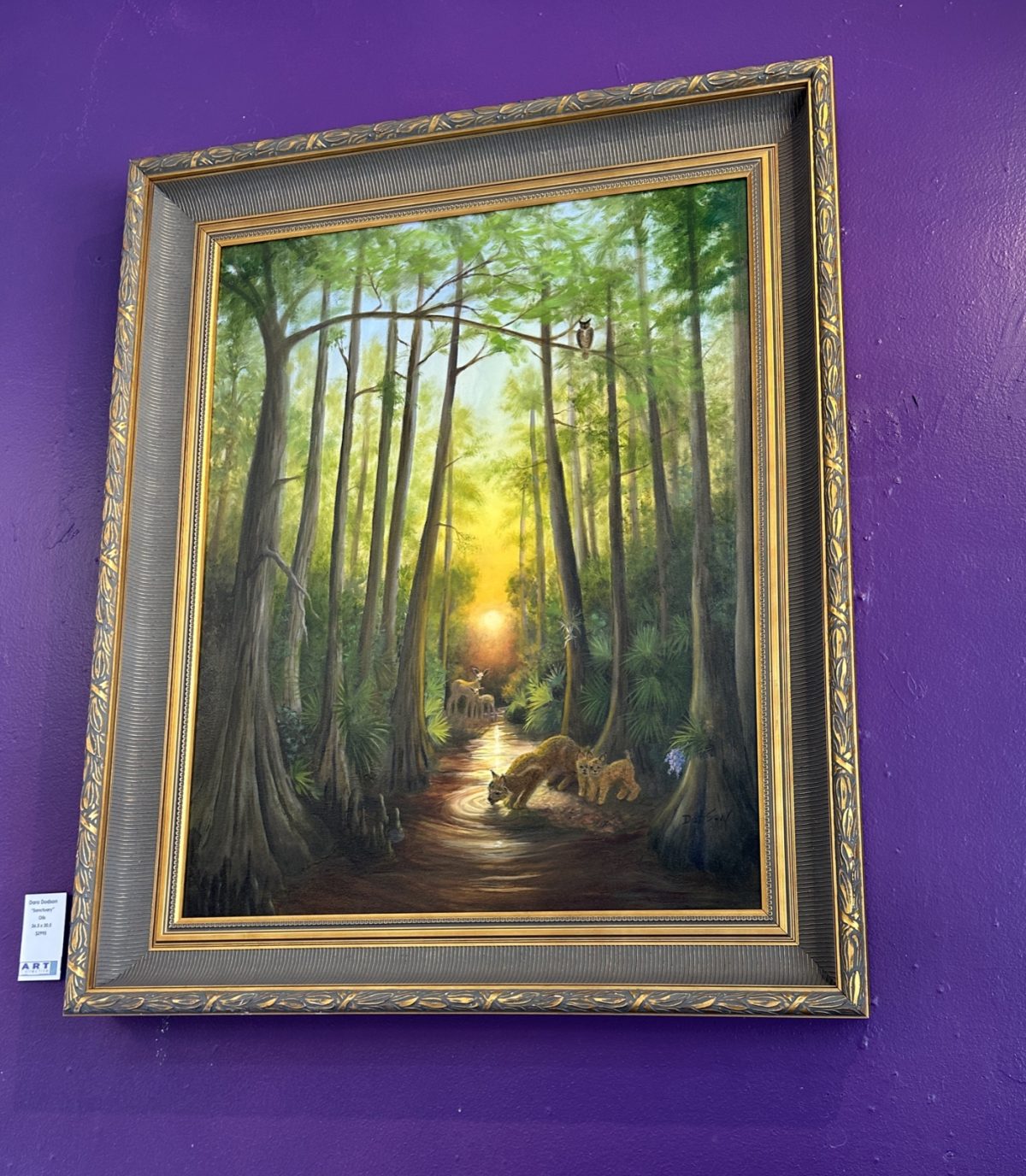 'Sanctuary,' oils, 36.5 by 30.5 inches: a bobcat and kittens drink from a cypress creek.