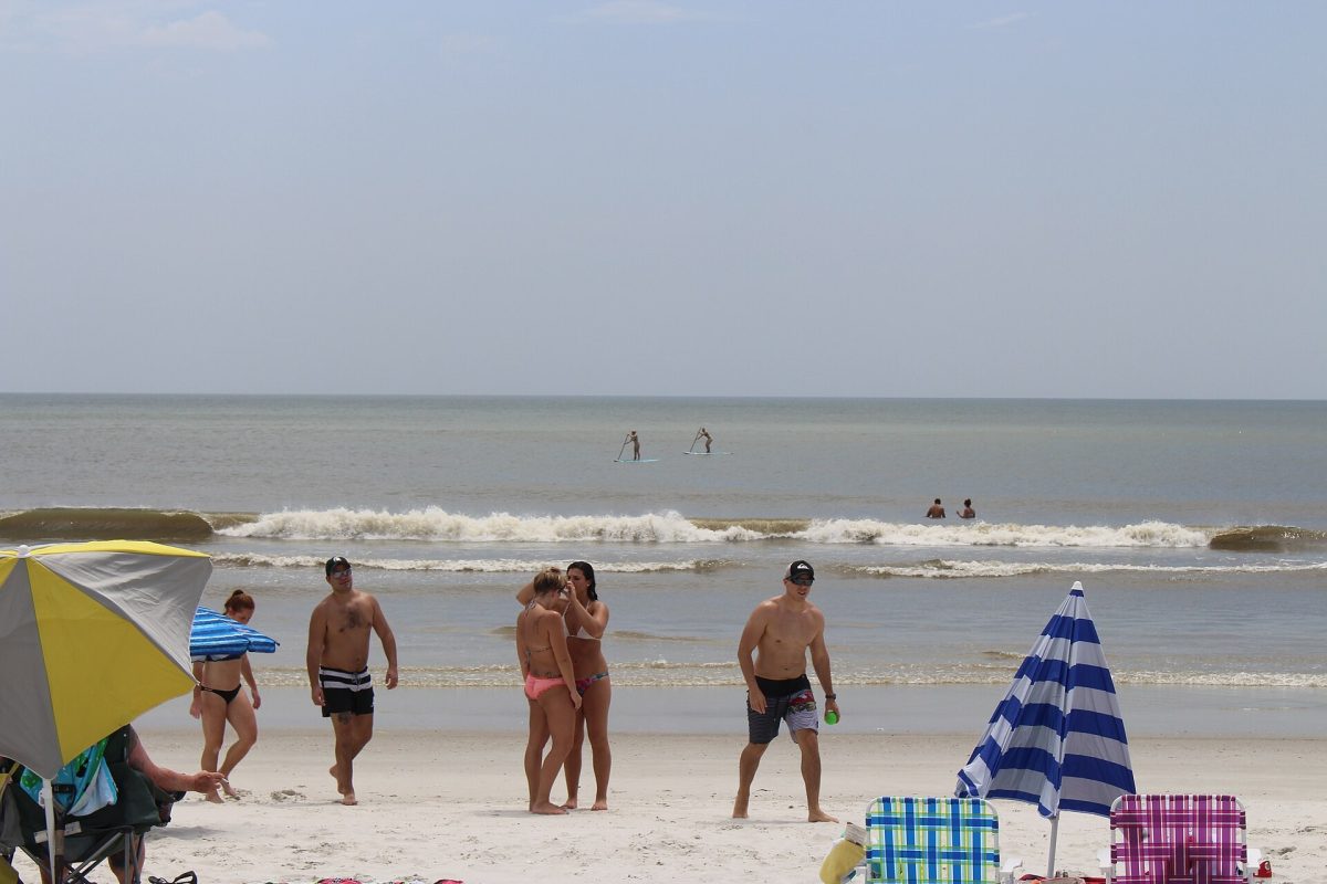 Paddleboarders and beachgoers at Neptune Beach.